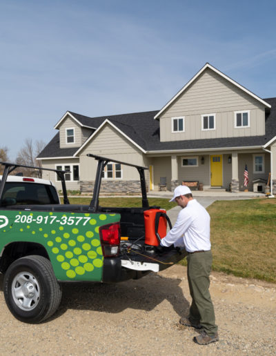 Evade Pest Management technician preparing to perform pest control treatment on a home
